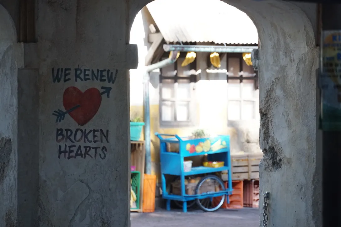 A wall painted with 'we renew broken hearts' at DIsney's Animal Kingdom.