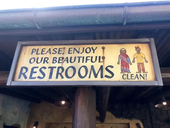 Themed restroom signage saying 'Please enjoy our beautiful restrooms'